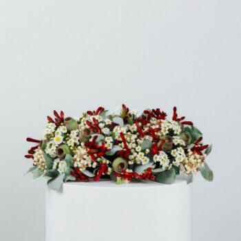 table centre piece made with australian native flowers gumnuts and foliage rectangle thirty centimetres long